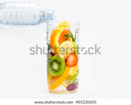 Infused water with fresh organic berries and fruits on white background Royalty-Free Stock Photo #403220605