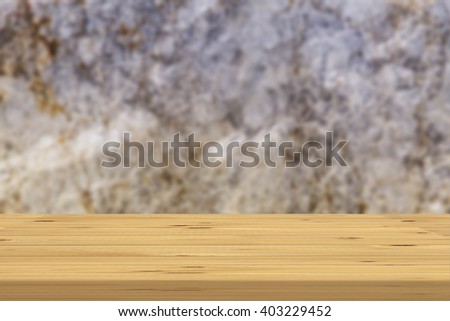 Wood table top on bare concrete wall background