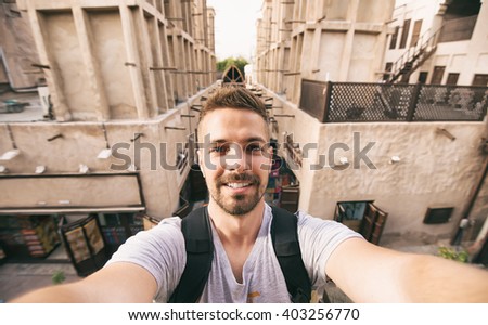 Tourist making selfie at old arabian town.