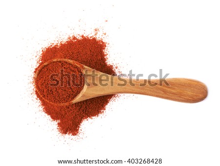 Wooden spoon over the pile of paprika isolated over the white background