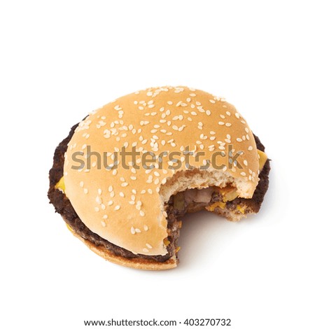 Fresh cooked hamburger with a single bite taken, composition isolated over the white background