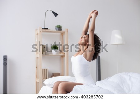 Cheerful woman is waking up Royalty-Free Stock Photo #403285702