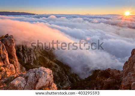 Ocean of a cloud and sky of dawn. Crimea. Gore Ay-Petri. Mountain landscape. Mountain cloudy landscape. Cloudy landscape. Crimean landscape. Clouds are painted by flowers of dawn. Mountain top. Royalty-Free Stock Photo #403295593