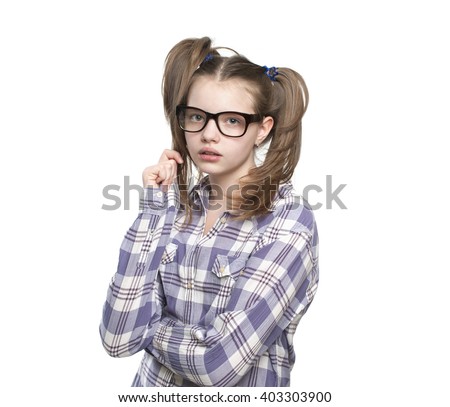 Portrait of teen girl in a plaid shirt.
Studio photography on a white background. Age of child 11 years.