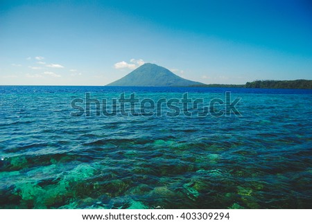 Manado Tua island near Bunaken Island in Sulawesi Royalty-Free Stock Photo #403309294