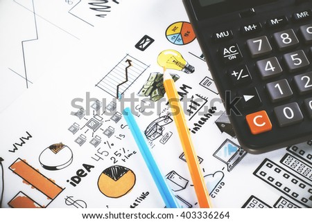 Closeup of calculator and pencils on business charts