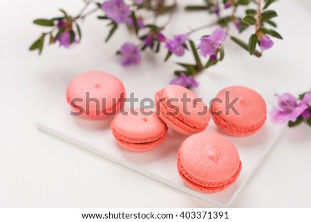 Bright macaroons on the wooden background. Shallow depth of field.