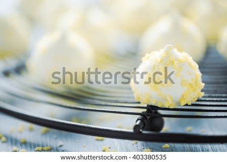 Lemon meringue on cooling tray, with defocused background.