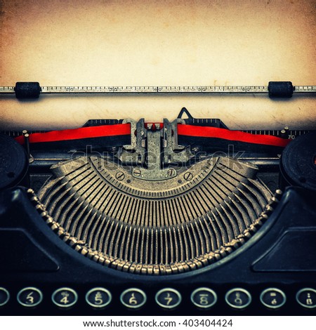 Antique typewriter with aged textured paper sheet. Vintage style toned photo