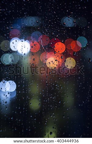 rainy days ,rain drops on the window with traffic bokeh light 