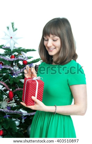 young  attractive woman with  red gift near christmas tree. isolated on white background