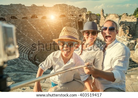 Young positive famly take a vacation photo on the Side ampitheatre view