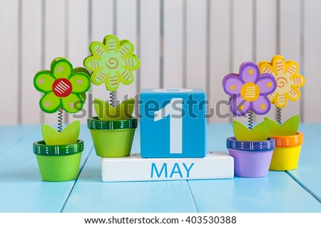 May 1st. Image of may 1 wooden color calendar on white background with flowers. Spring day, empty space for text.  International Workers' Day Royalty-Free Stock Photo #403530388