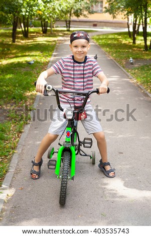 cute little boy riding the bicycle