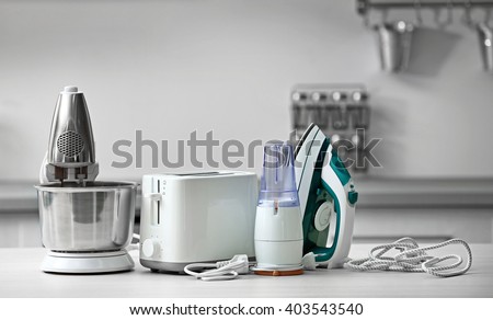 Household and kitchen appliances on the table in kitchen Royalty-Free Stock Photo #403543540