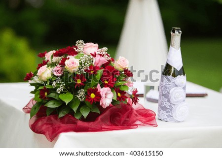 bridal bouquet and champagne Royalty-Free Stock Photo #403615150