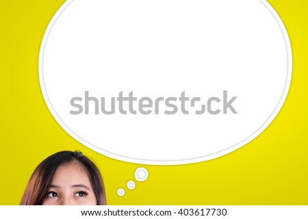 Eyes of Asian woman looking at empty thought bubble above for copy space, over yellow background