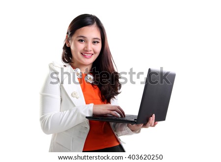 Charming young Asian office lady smiling at camera while using a laptop, isolated on white background