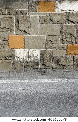 Background colored brick wall fence with sidewalk