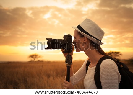 Female photographer shooting in a beautiful outdoor setting.