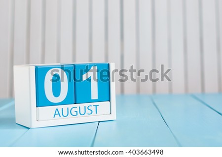 August 1st. Image of august 1 wooden color calendar on blue background. Summer day. Empty space for text