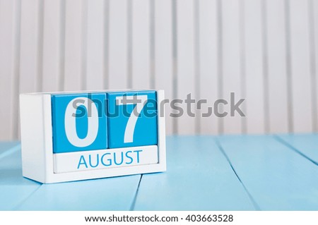 August 7th. Image of august 7 wooden color calendar on blue background. Summer day. Empty space for text