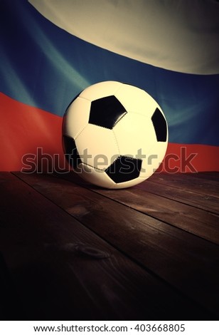 Flag of Russia with football on wooden boards as the background. Vintage Style.