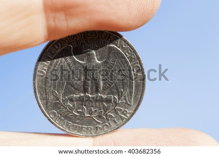   photographed close-up of a quarter of the US dollar in the hands of a man,