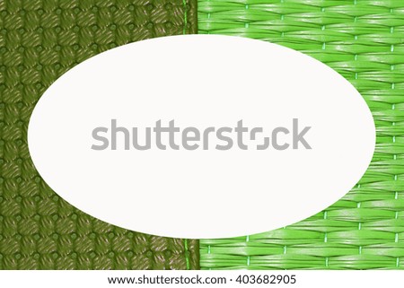 Green picture frame on woven mats