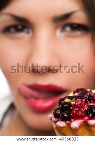 Young beautiful woman with a cake. Close-up studio portrait. isolated on white