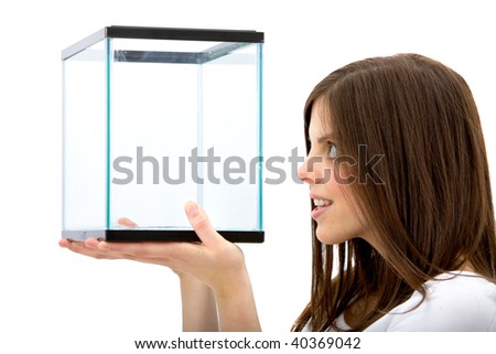 woman looking at an empty fish tank isolated