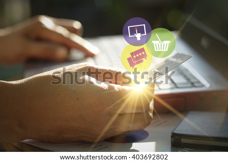hand holding credit card with internet icon  application software icons on laptop , business concept