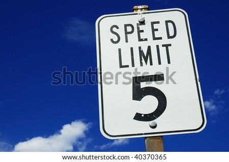 5 mile an hour speed limit sign against blue sky
