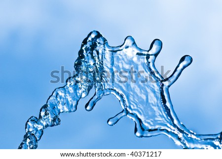 Beautiful splashes of water on a background blue sky