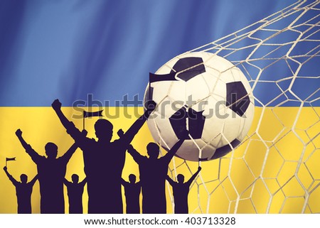 silhouettes of Soccer fans with flag of Ukraine .Cheer Concept vintage color