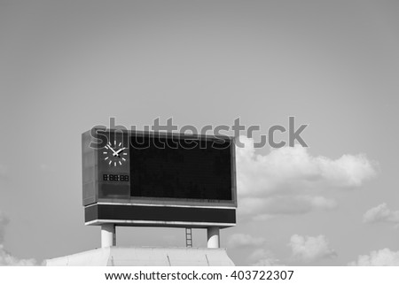 score board at football stadium with bluesky , black and white.