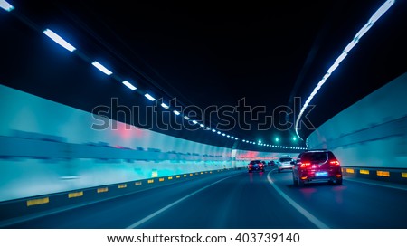 car driving through tunnel Royalty-Free Stock Photo #403739140