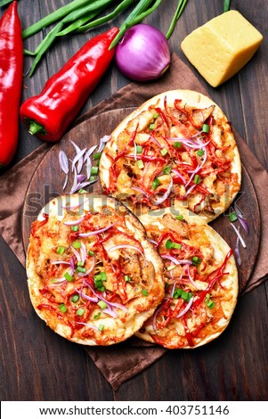 Delicious pizza with red pepper on wooden table, top view