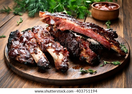 Roasted sliced barbecue pork ribs, focus on sliced meat Royalty-Free Stock Photo #403751194