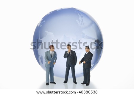 Figures of the businessman who communicates by the side of a globe of glass.
