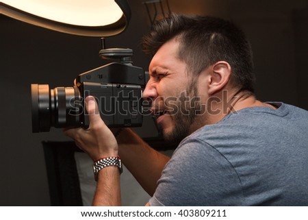 photographer with a medium format camera in the studio