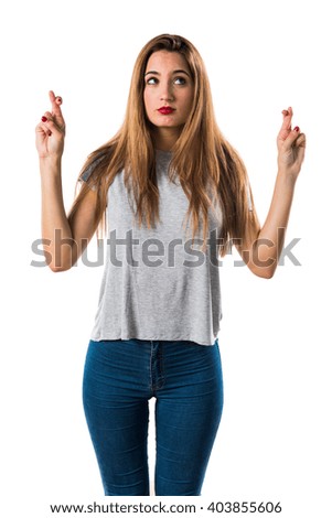 Young girl with her fingers crossing