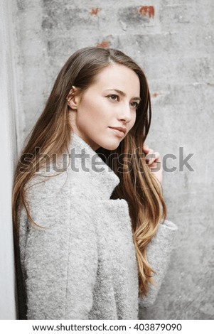 Beautiful woman in gray looking away