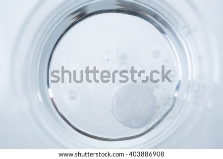 Topview of water glass with dissolving tablet