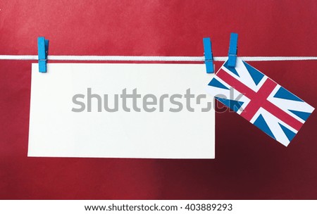 white paper sticker (space for text), British flag hanging pegs. Union Jack flag. Concept - wishes for the holidays, information text, messages