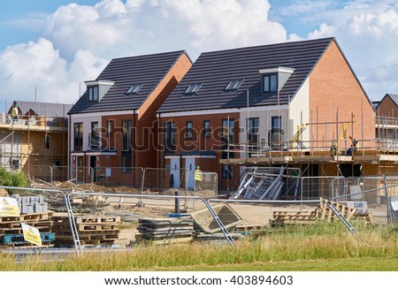 Newly built homes in a residential estate in England.                                 Royalty-Free Stock Photo #403894603