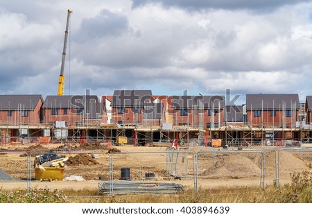 Newly built homes in a residential estate in England.                                 Royalty-Free Stock Photo #403894639