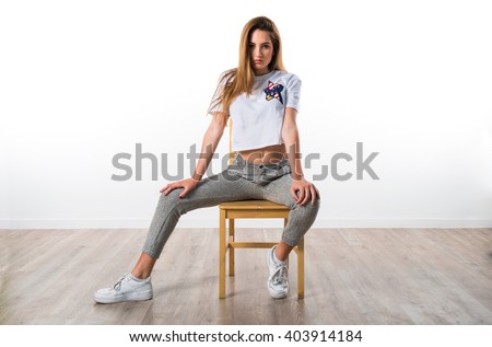 Blonde girl posing on chair