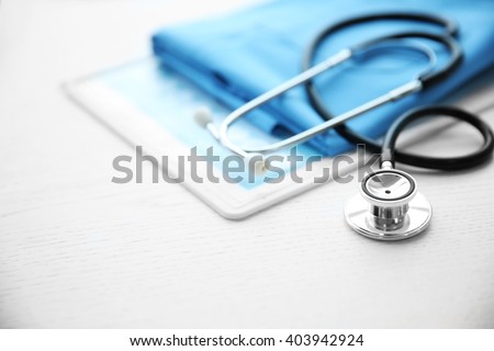 Stethoscope and medical equipment on a light blue background Royalty-Free Stock Photo #403942924