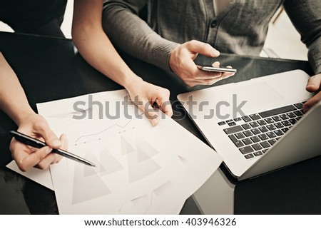 Business situation, team work. Closeup photo finance manager working modern office with new business project. Using laptop,smartphone, startup idea. Horizontal. Blurred background,film effect